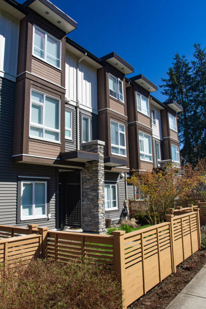 istock Modern low rise wood frame complex. Brand new apartment building on sunny day in spring with blooming trees. 1060807926