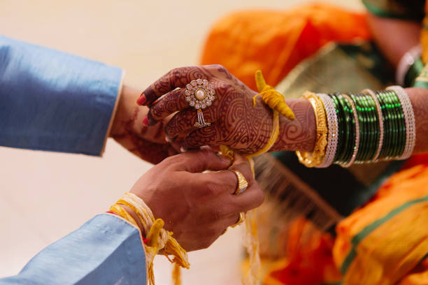 istock Wedding ritual, Kankana Dhaarana, a turmeric-stained thread wrapped around a turmeric root. 1060808474