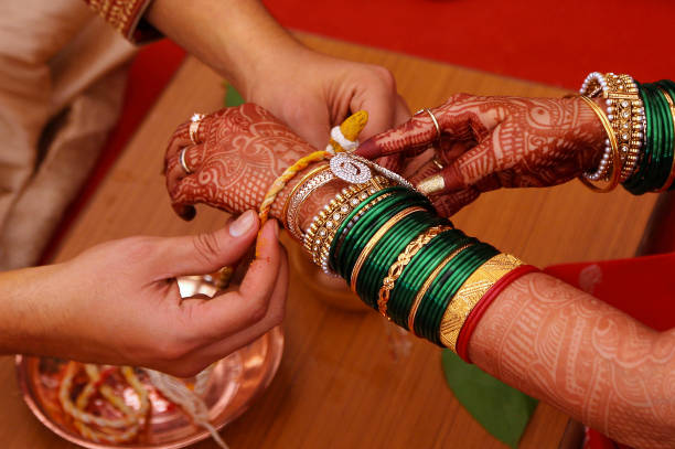 istock Wedding ritual, Kankana Dhaarana, a turmeric-stained thread wrapped around a turmeric root. 1060808514