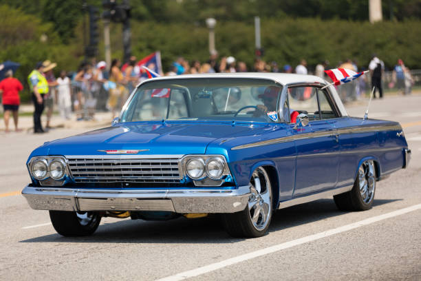The Puerto Rican Day Parade Chicago, Illinois, USA - June 16, 2018: The Puerto Rican Day Parade, Puerto RIcan driving a Chevrolet Bel Air blue Classic car with puerto rican flags during the parade bel air photos stock pictures, royalty-free photos & images