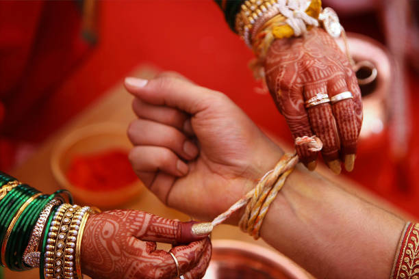 istock Wedding ritual, Kankana Dhaarana, a turmeric-stained thread wrapped around a turmeric root. 1060808746