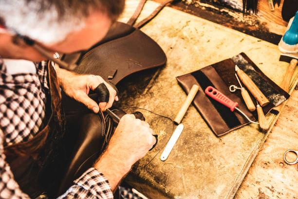 istock A saddle maker making a custom made saddle.  Real person, real life. 1060809140