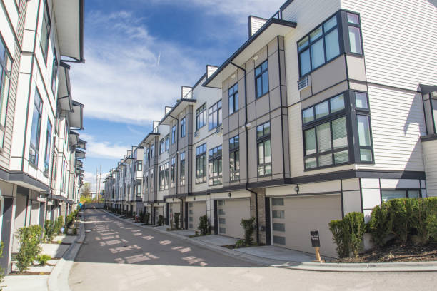 Nice development of new townhouses. External facade of a row of colorful modern urban townhouses.brand new houses just after construction on real estate market stock photo