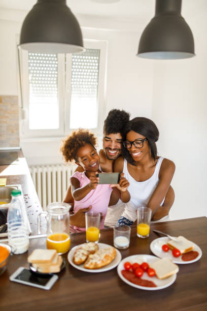 istock Cheerful family taking Selfie during breakfast 1060812018