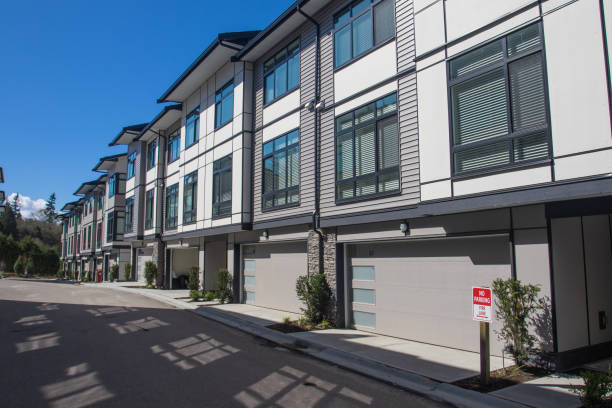 Nice development of new townhouses. Rows of townhomes side by side. External facade of a row of colorful modern urban townhouses. brand new houses just after construction on real estate market stock photo