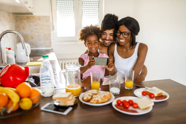 istock Cheerful family taking Selfie during breakfast 1060816158
