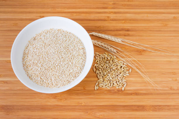 istock Raw fine-ground barley groat, barley whole grains and ears 1060816596