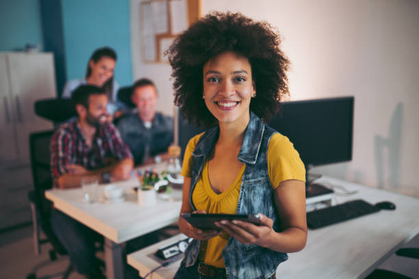 istock Smiling business woman at workplace using digital tablet 1060816644