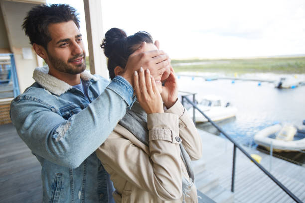 istock Positive man making surprise for girlfriend 1060820906