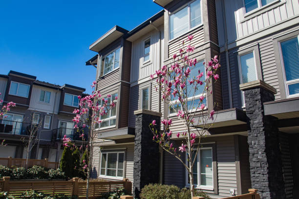 istock Brand new apartment building on sunny day in spring with blooming trees. 1060820986