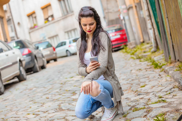 istock Cute young woman using cellphone in urban surroundings. 1060821176