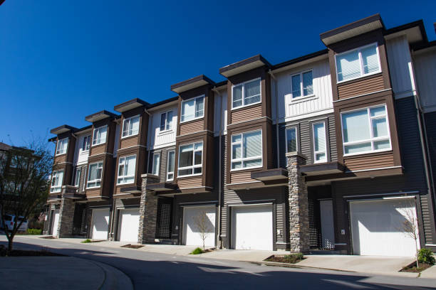 istock Brand new apartment building on sunny day in spring with blooming trees. 1060821284