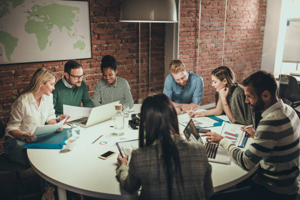 istock Business team sitting at the table in the office and analyzing business reports. 1060827158