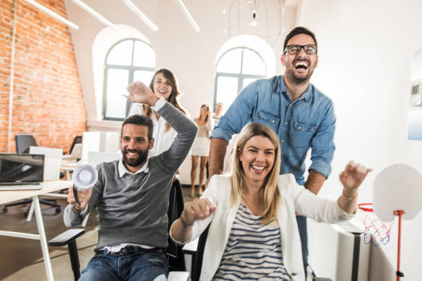 istock Group of cheerful business colleagues having fun in the office. 1060827928