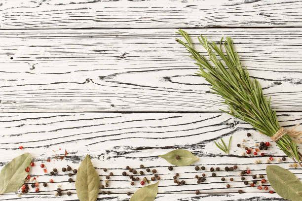 istock background rosemary, chili pepper on a wooden table 1060829866