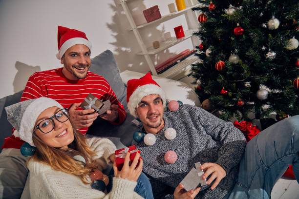 istock Three friends sharing Cristmas / New Year's eve  presents. 1060830718