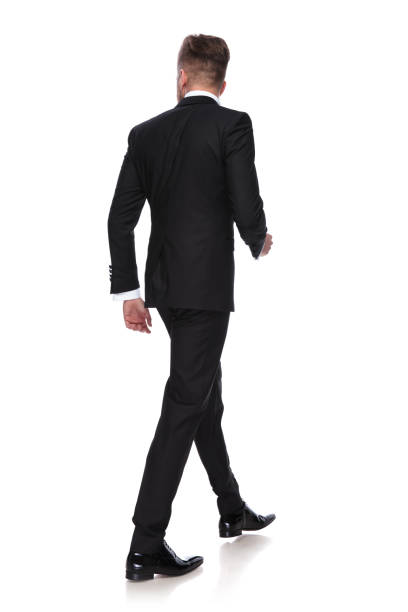 istock back view of a young man in tuxedo walking 1060835420