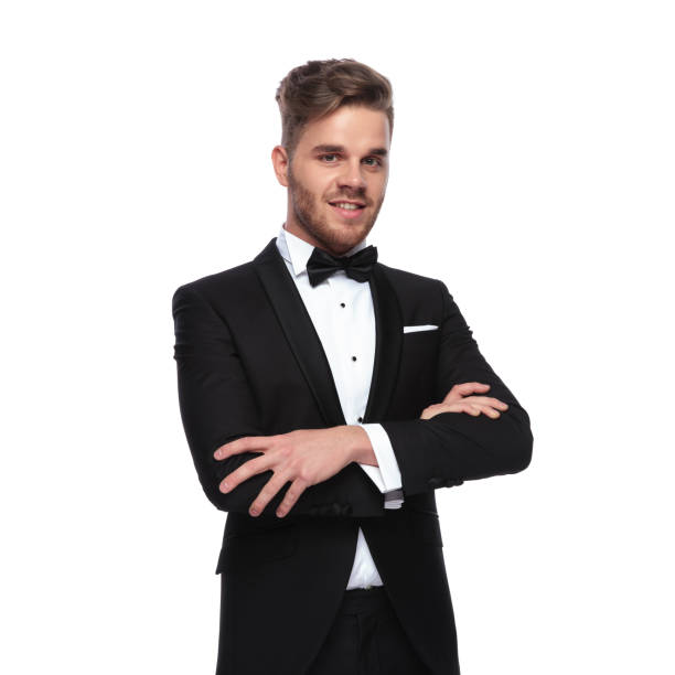 istock smiling elegant man in tuxedo standing with hands crossed 1060835452