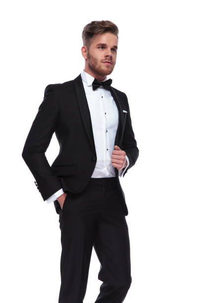istock man in tuxedo with hand in pocket and holding collar 1060835564