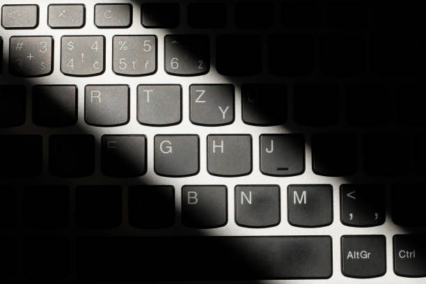 istock Laptop keyboard with a diagonal highlight and shadows 1060837958