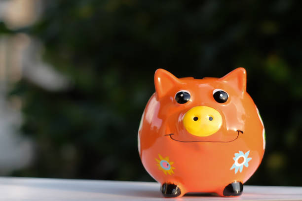 istock Piggy bank outside, trees in background 1060837972