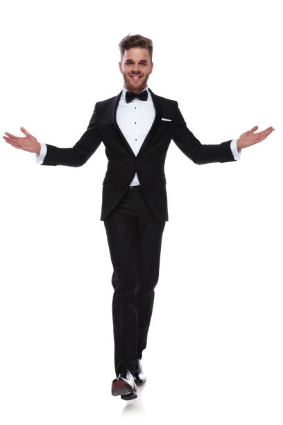 istock smiling young elegant man walking and welcoming 1060838302