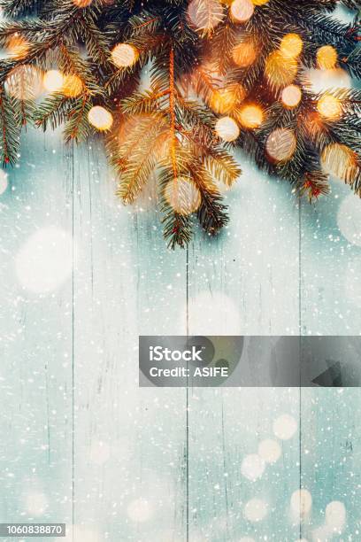 Christmas Fir Branches With Lights On Wooden Planks Stock Photo - Download Image Now