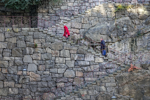 Stockholm, Sweden - October 22, 2018: Old couple walk up for old stone stairs on the island Södermalm, Stockholm.