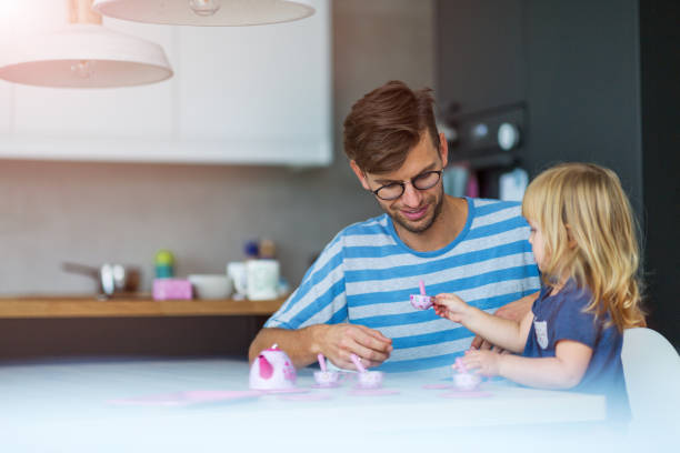 istock Father and daughter having a tea party at home 1060841810