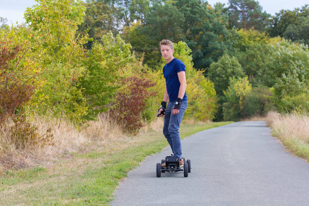 istock Young caucasian man rides electric mountainboard on road 1060843800