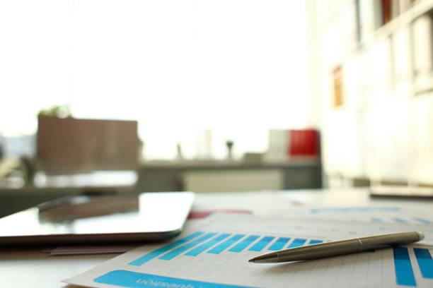 istock Silver pen lie at important paper on table 1060846474