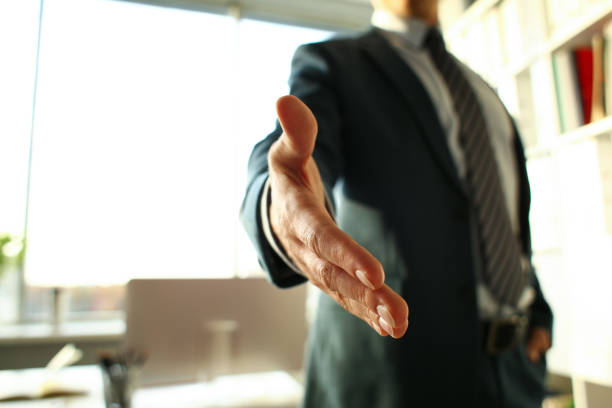 istock Man in suit and tie give hand as hello 1060846492