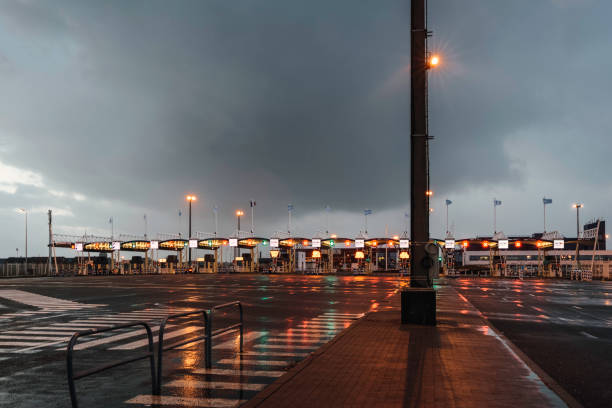 Toll booth in Calais on rainy evening Calais, France - December 30, 2013: Toll booth in the harbor on rainy day at dusk. International border to UK. doncaster photos stock pictures, royalty-free photos & images