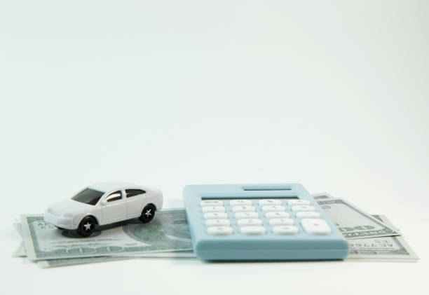 istock white car toy and blue calculator white background. 1060850054
