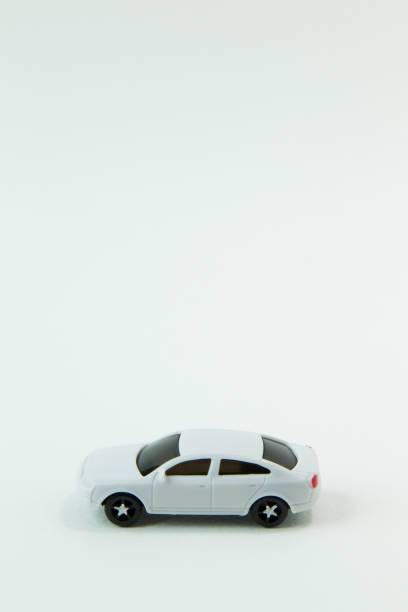 istock white car toy and gold coin on  white background. 1060850418