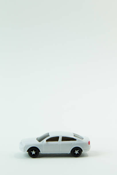 istock white car toy and gold coin on  white background. 1060850454