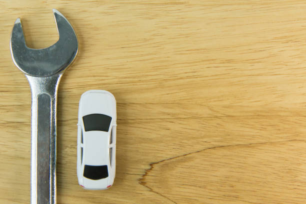 istock white car toy on wood table  image close up. 1060850730