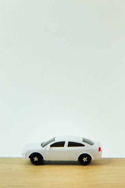 istock white car toy on wood table  image close up. 1060850820