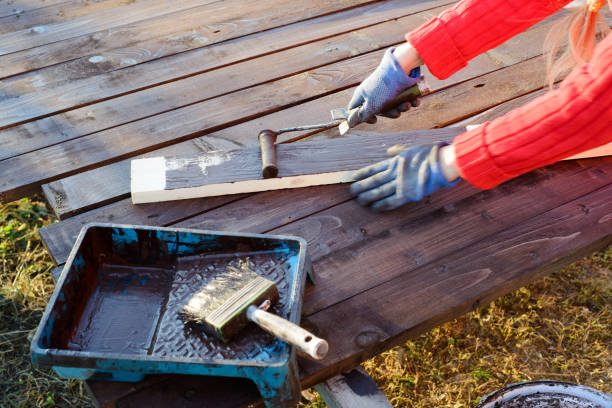 istock Female hand painting wood with paint roller 1060855250
