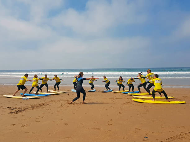 Surfers getting surfers lessons at Praia Vale Figueieras in Portugal stock photo