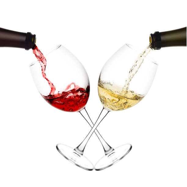 istock red and white wine poured from a bottle into wine glass on white background, isolated 1060856562
