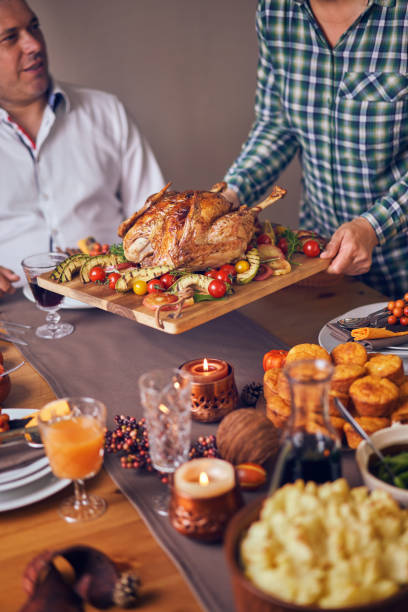 istock Family Having Traditional Holiday Stuffed Turkey Dinner 1060858054