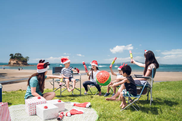 Christmas Crackers. Kids enjoying a Christmas part at beach in Auckland, New Zealand. rangitoto island stock pictures, royalty-free photos & images