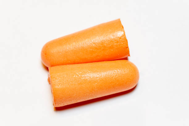istock two orange ear plugs on a white background 1060858438