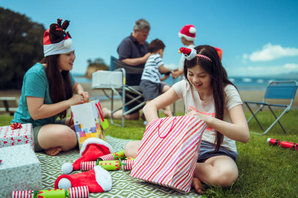 Christmas gifts. Kids enjoying a Christmas part at beach in Auckland, New Zealand. rangitoto island stock pictures, royalty-free photos & images