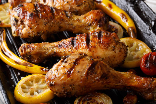 istock Grilled chicken drumstick legs with vegetables in the grill pan close-up. horizontal 1060858546