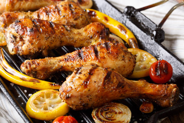 istock Freshly cooked grilled chicken drumstick legs with vegetables in a grill pan close-up. horizontal 1060858946