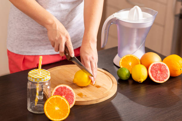 istock Woman cutting lemon 1060859206