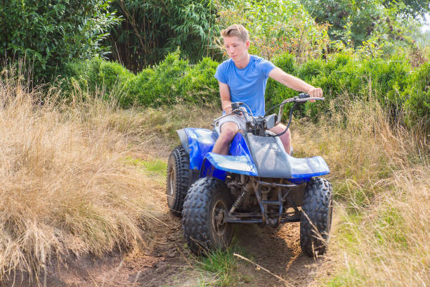 istock Teenage boy driving quad through curve 1060860518