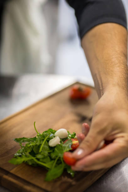 istock Cook Preparing Various Ingredients and Vegetables on a Wooden Cutting Board 1060864640